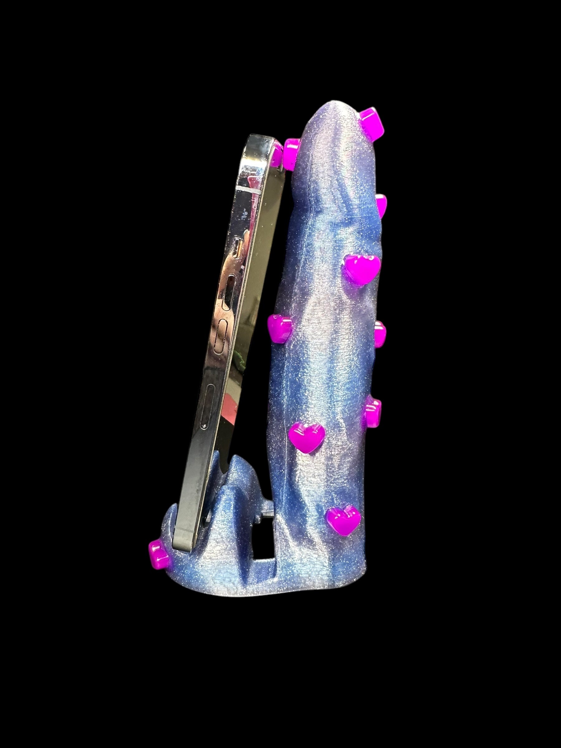 3D-printed phone holder in cosmic blue with pink heart studs, side view holding a phone.